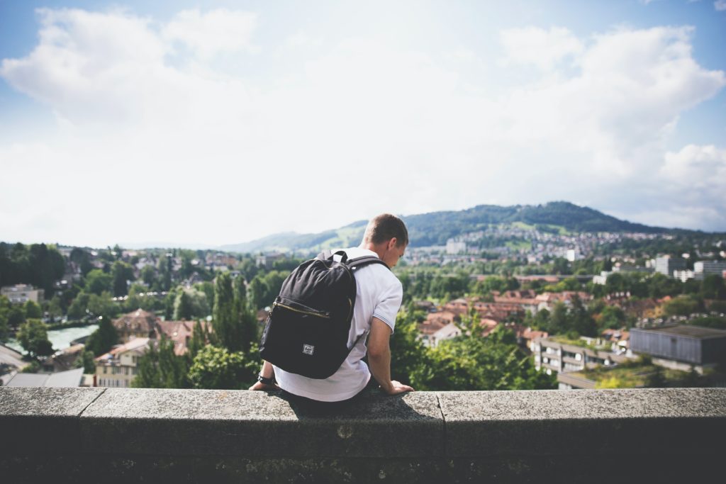 Young male student looking over a city