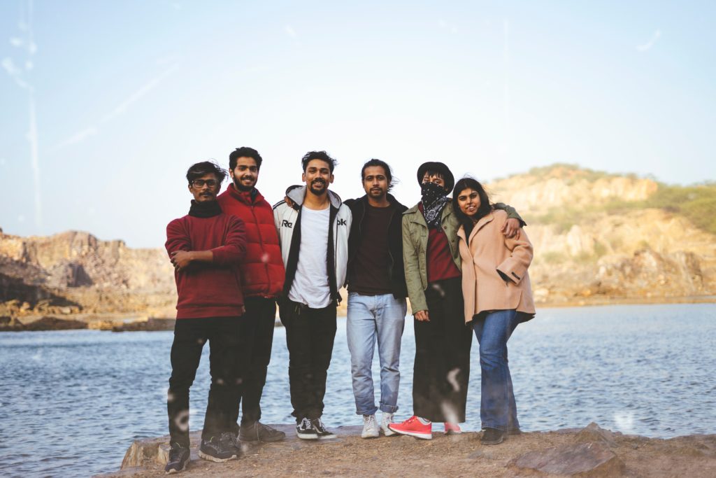 Group of students posing in front of a lake