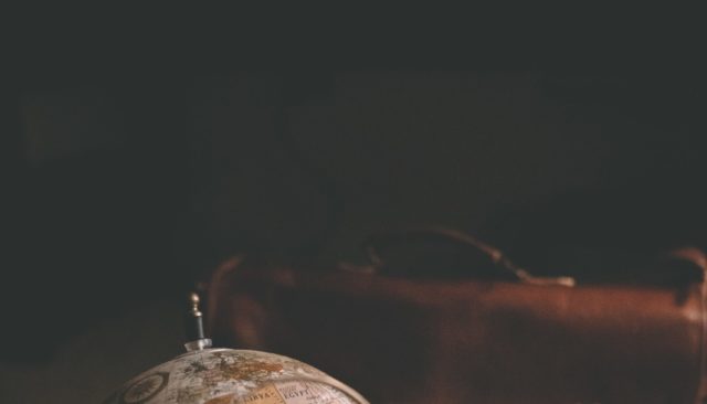 Magnifying glass pointing on a globe