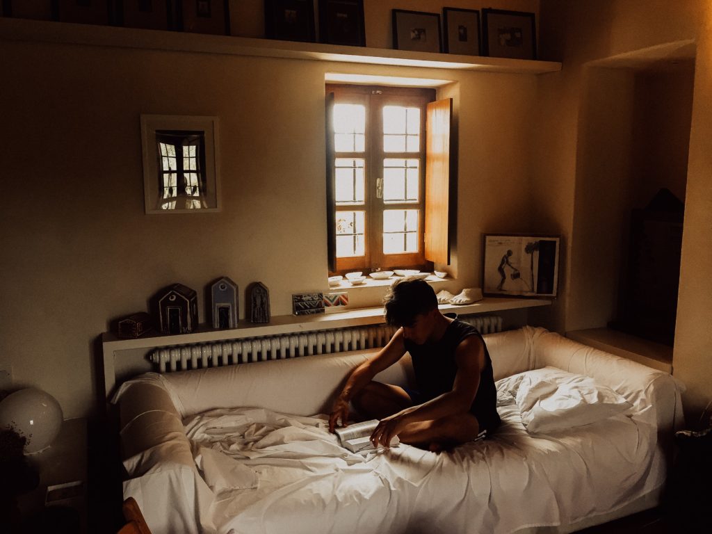 student reading in his student accommodation