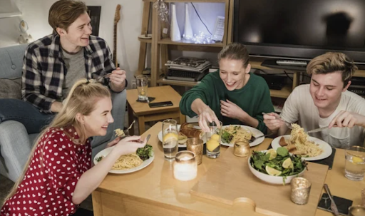 university students having a meal in their private flat