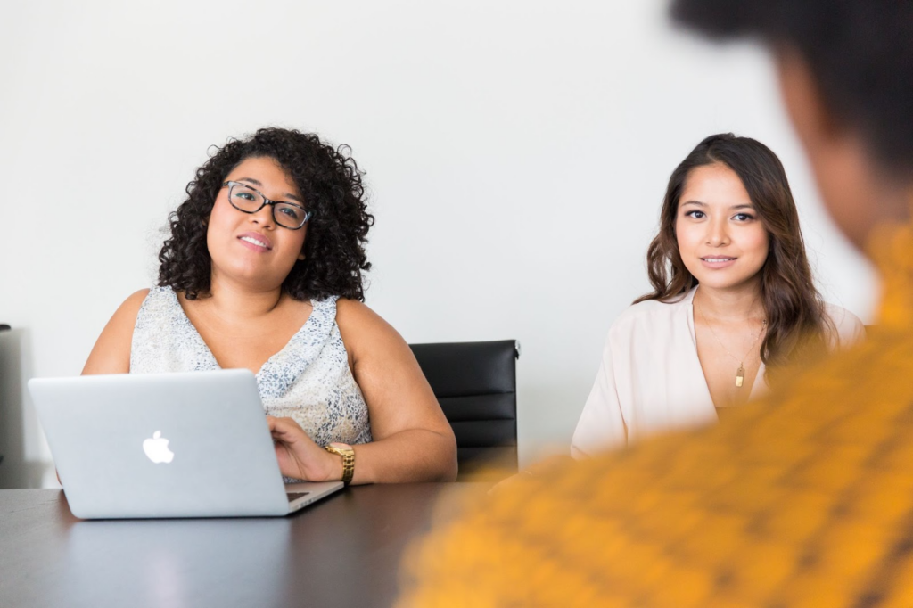 Two women interviewing a candidate for a job