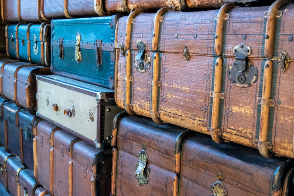 A variety of suitcases piled on top of each other