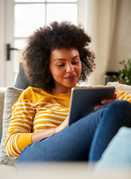 Woman relaxing in her sofa while on her tablet